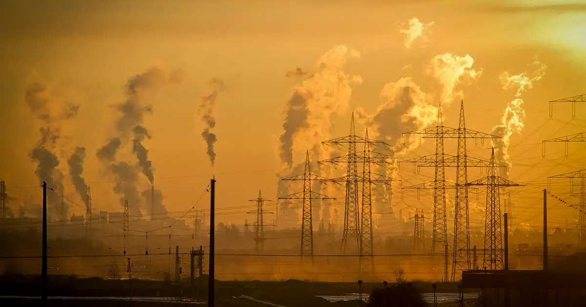 A Texas landscape of power lines and smoke rising from power plants.