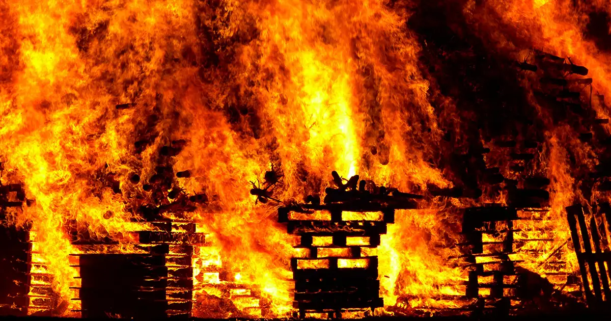 A house is engulfed in flames, a total loss because of a household fire.