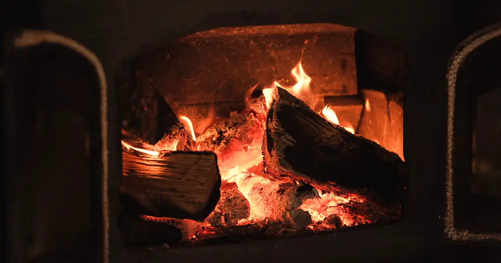 Wood burning in a fireplace.