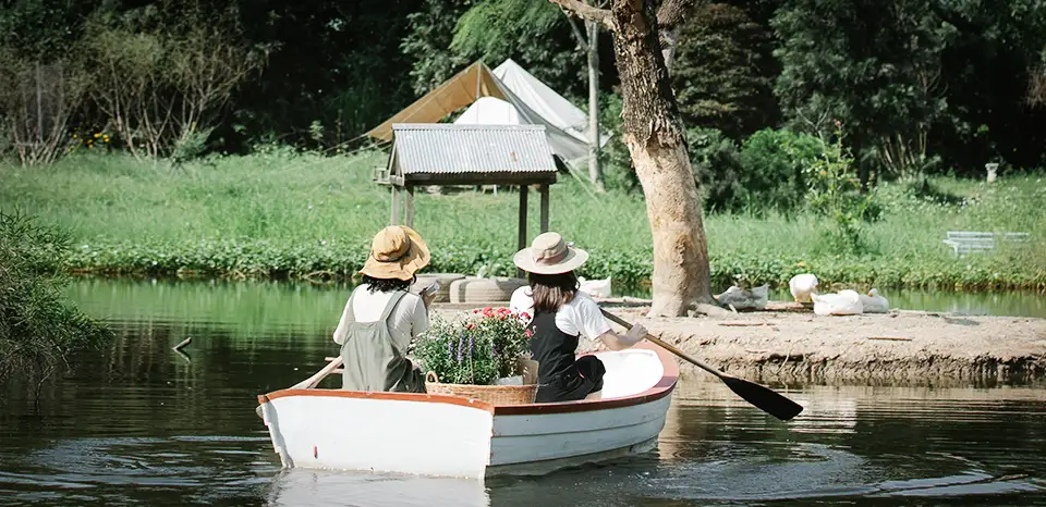 Two women in a row boat, on a Texas lake in summer.
