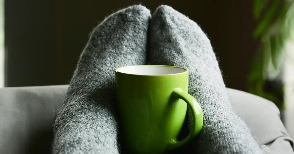 Staying snug and warm with socks and a cup of tea