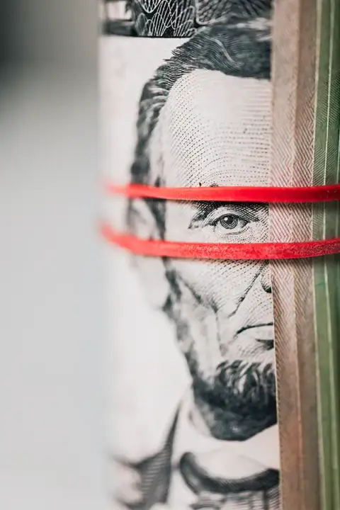 Abe Lincoln on a $5 bill keeping watch