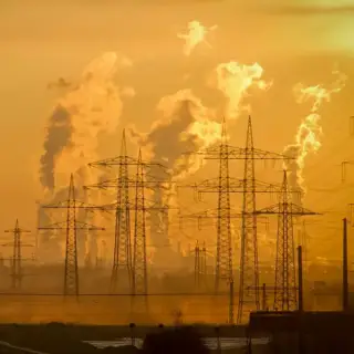 A Texas landscape of power lines and smoke rising from power plants.