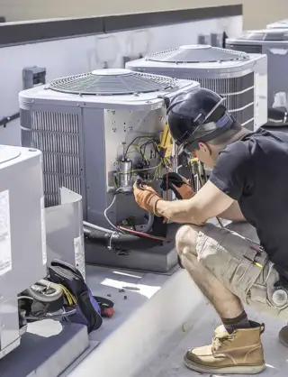 As a Home Warranty HVAC Service company in Dallas TX, a technician works on a unit